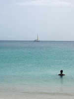 Woman watches boat - St. Kitts